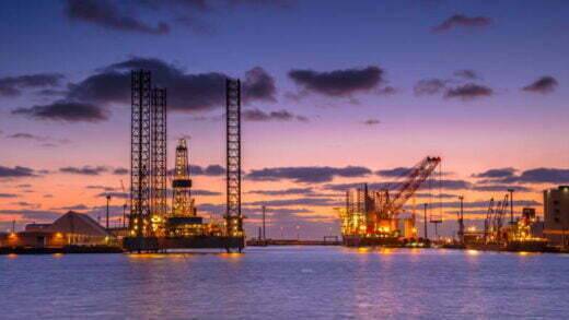 Oil Platforms being built in a harbor under beautiful sunset