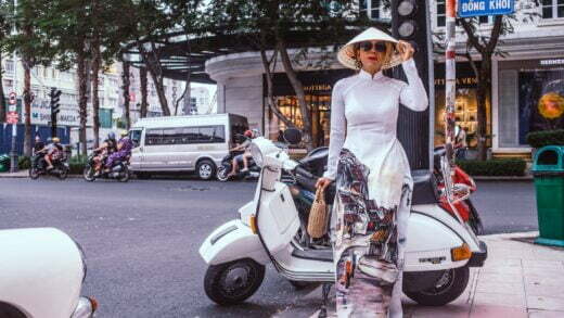 woman standing beside white motor scooter